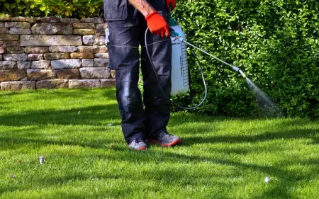 tech spraying grass for weeds