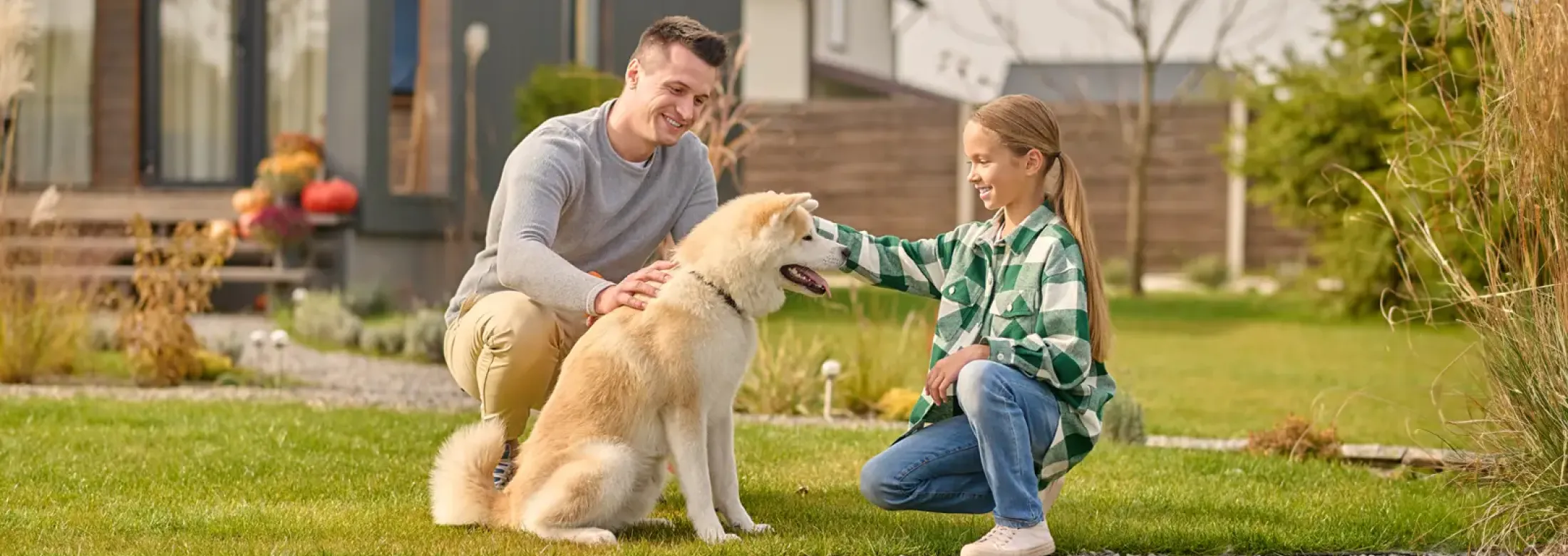 father and daughter petting dog